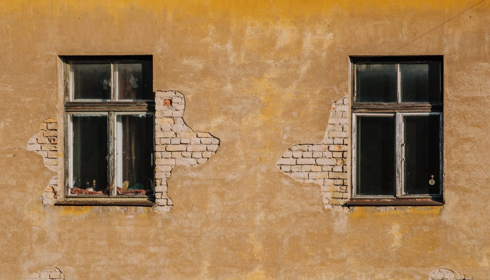 Photo of two windows of an old apartment building